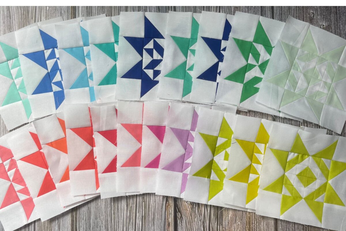 Twilight Stars quilt along. Picture shows 20 rainbow star quilt blocks with 3/4 inch half square triangles making up the center and flying geese on the outside