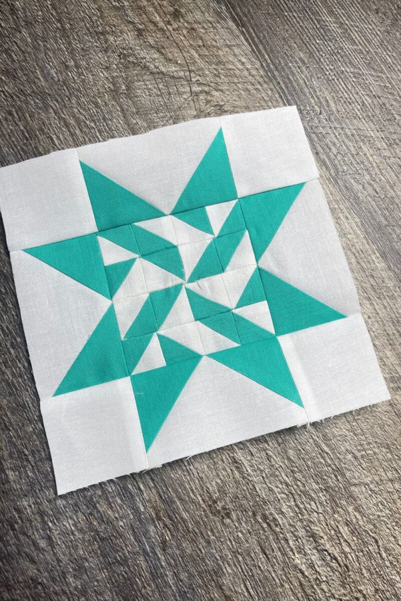Aqua and white quilt block made with half square triangles and flying geese. Block 8 from Triangle Gatherings book