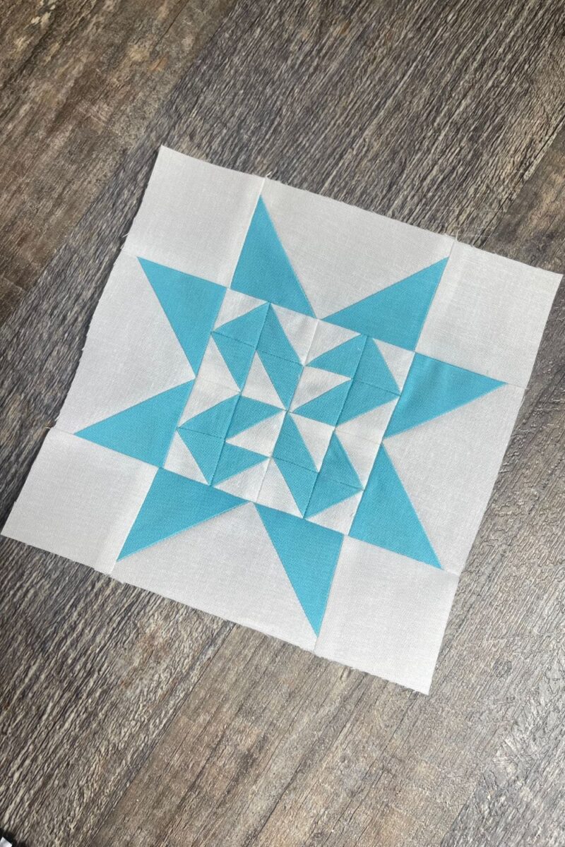 Blue and white quilt block. Block number 5 from the Triangle Gatherings quilt book. It is made with half square triangles and flying geese.