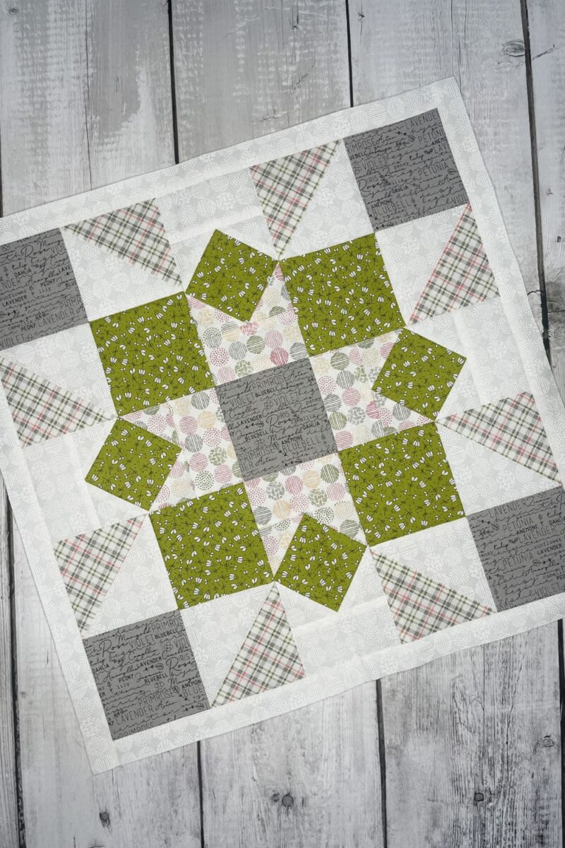 Peony Star quilt block from the Barn Star Sampler quilt along month 9. There are modified four patch corners and square in a square blocks to make up the larger block. Made with Spring Chicken and Renew fabric collections by Sweetwater