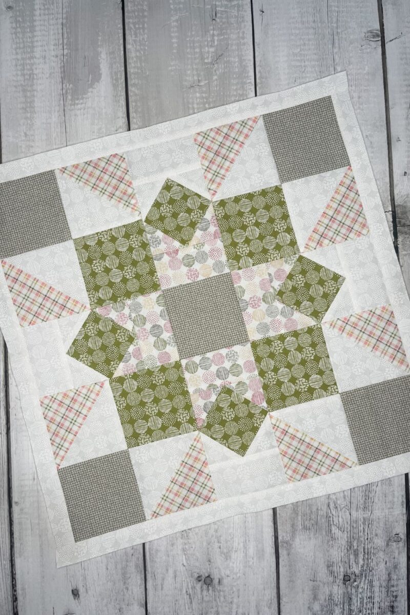 Peony Star quilt block from the Barn Star Sampler quilt along month 9. There are modified four patch corners and square in a square blocks to make up the larger block. Made with Spring Chicken and Renew fabric collections by Sweetwater