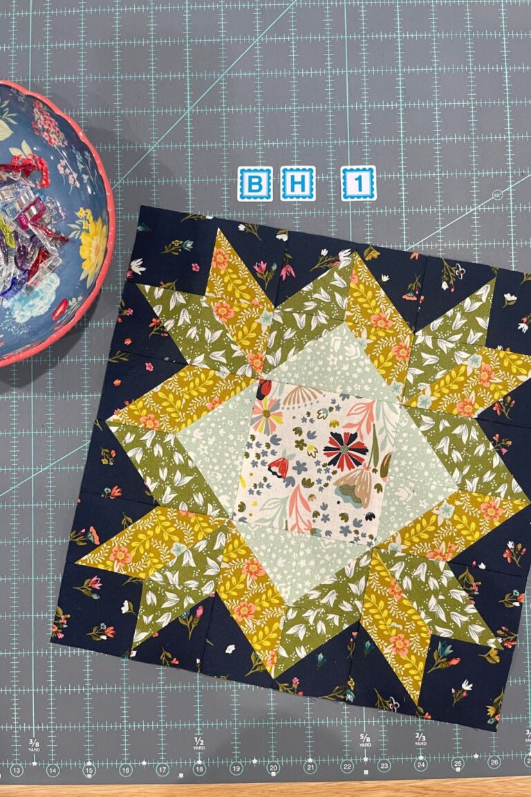 Moda Blockheads 5 quilt along block 1. Block uses Songbook fabrics and has half square triangles arranged into a star quilt block.