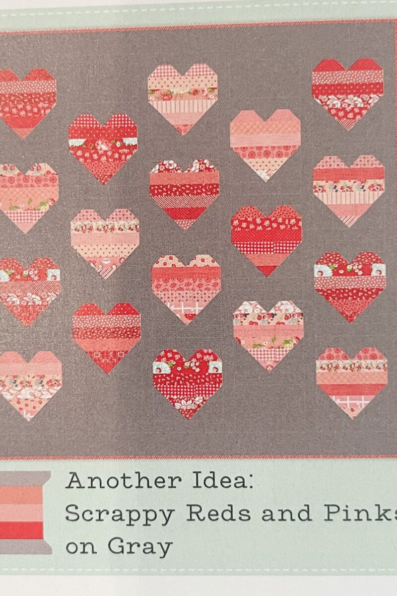 Scrap buster quilt idea picture from the Quilt Bee book by Bonnie and Camille. Scrappy Reds and Pinks with Grey background fabric.