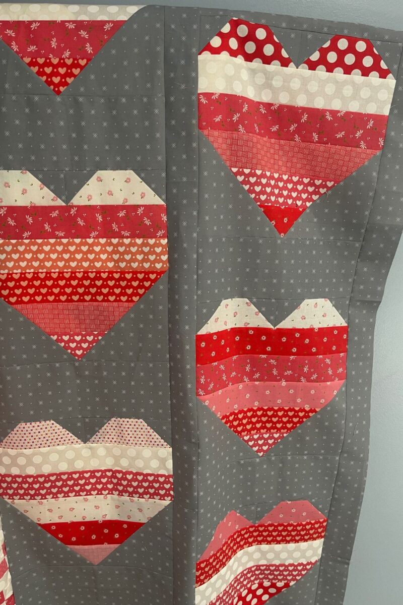 Rows of assembled heart quilt blocks.