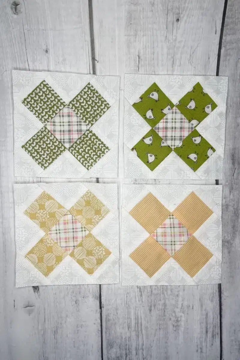 Barn Star Sampler Crisscross quilt blocks made with green and yellow fabrics on white background.