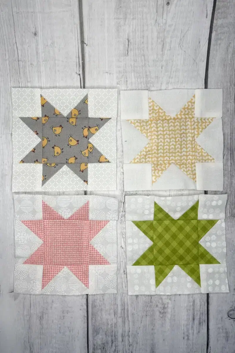 Sawtooth star blocks in grey, yellow, pink, and green.