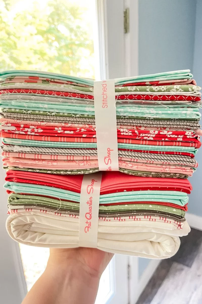 The fabric stack for the Shine Bright Sampler Quilt kit. Includes mostly Lighthearted fabrics plus a few others from other collections.