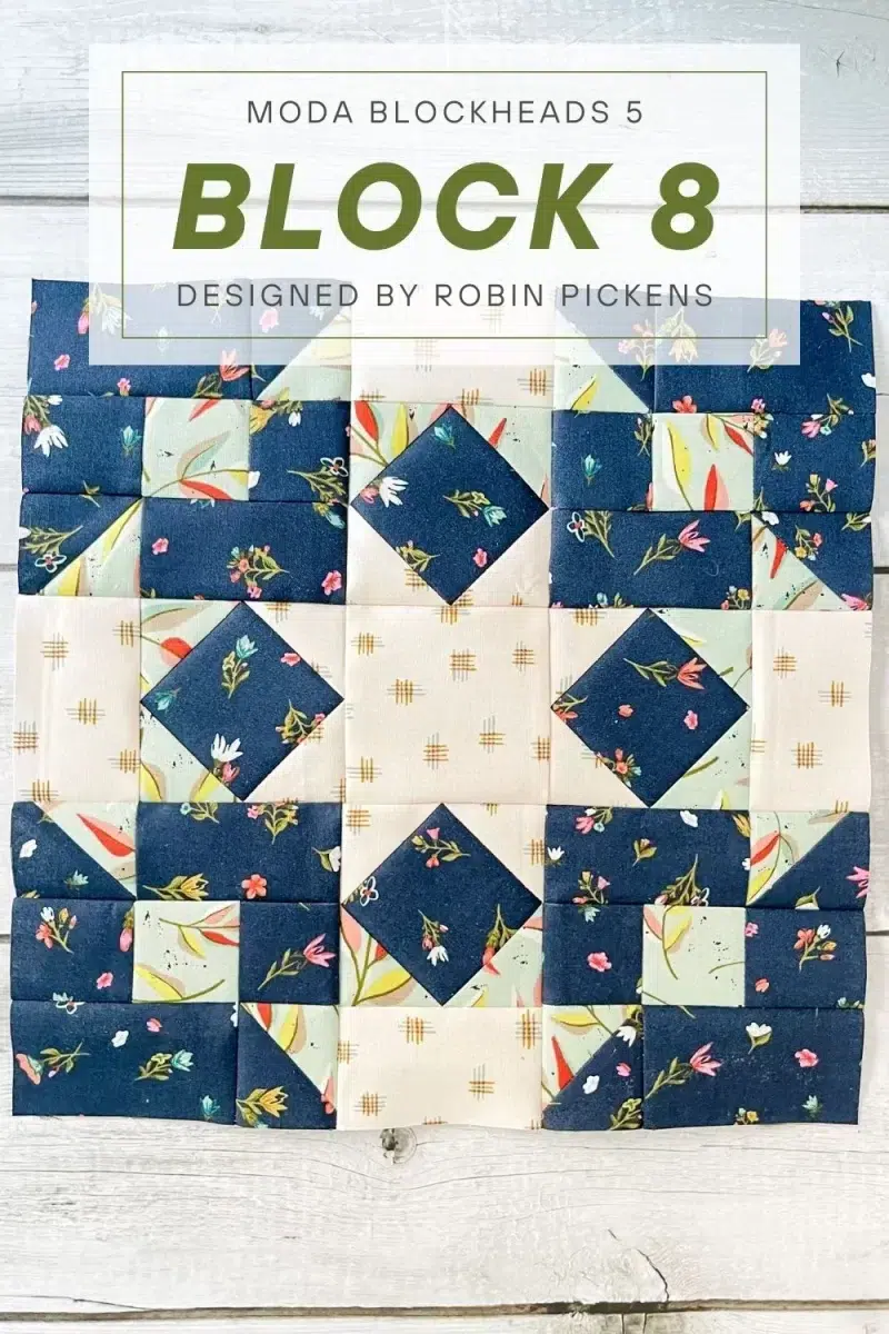 Community Star quilt block in Songbook fabric collection. Block is primarily navy floral with square in a square and nine patch components.