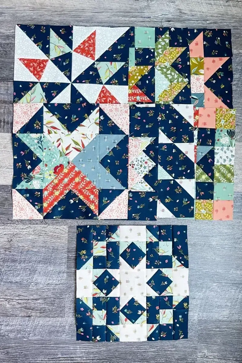 Community Star quilt block in Songbook fabric collection. Block is primarily navy floral with square in a square and nine patch components. Also shown is the 8 other Blockheads blocks stacked up.