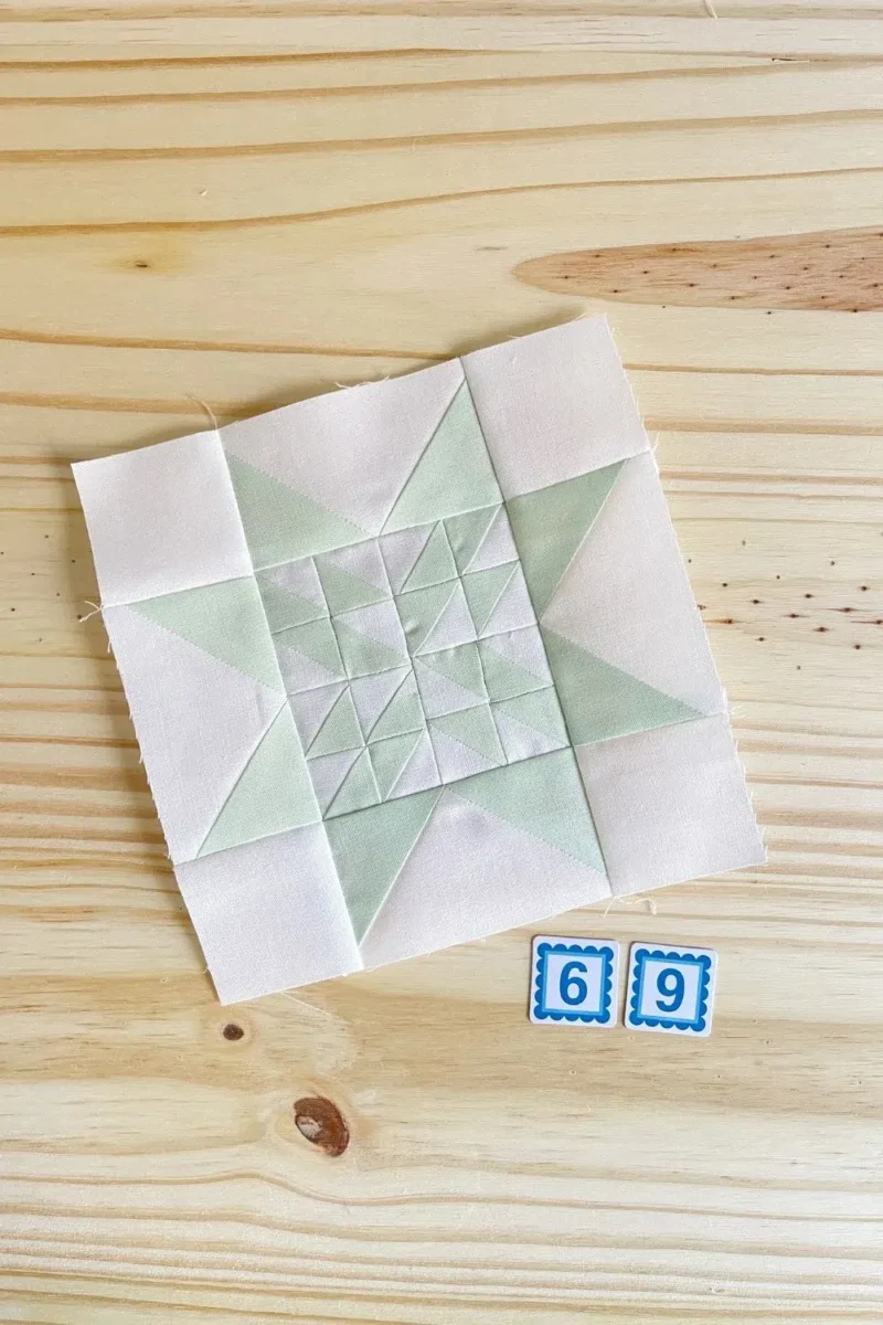 Star quilt block in light green and white. Made with 16 half square triangles in the center part of the star.