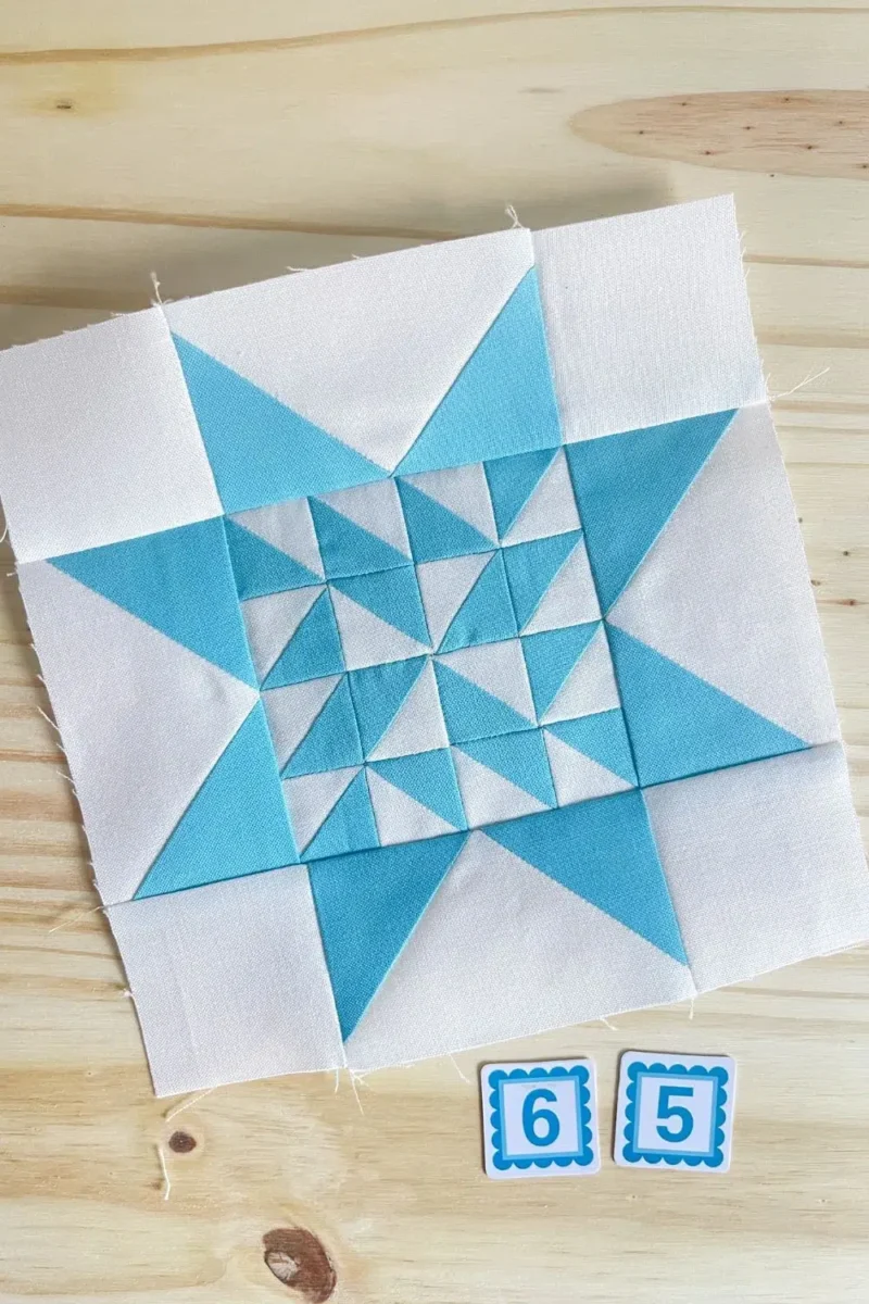 Star quilt block in aquamarine and white. Made with 16 half square triangles in the center part of the star.