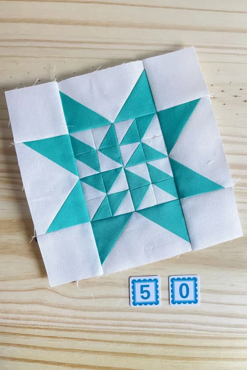 Star quilt block in aqua and white. Made with 16 half square triangles in the center part of the star.