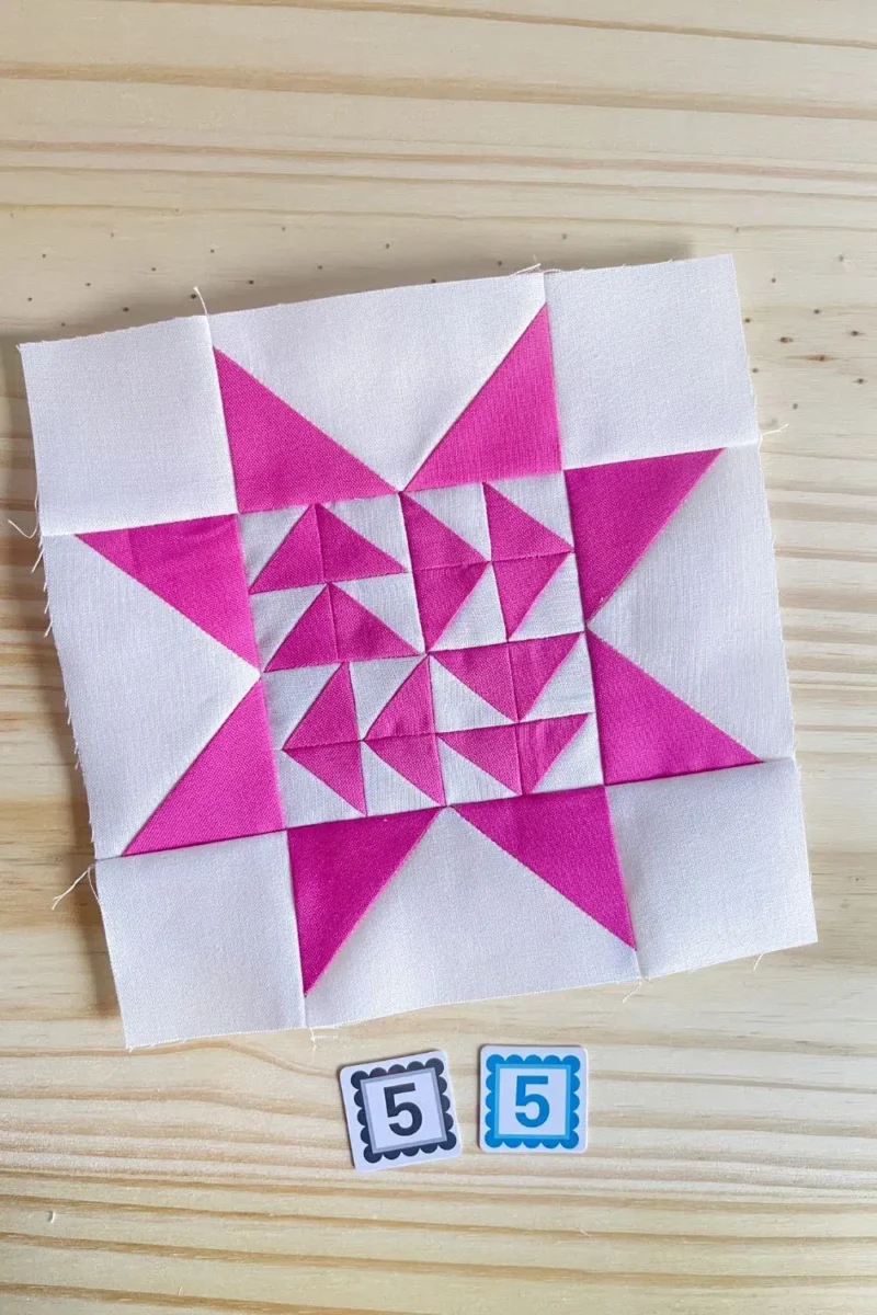 Star quilt block in pink and white. Made with 16 half square triangles in the center part of the star.