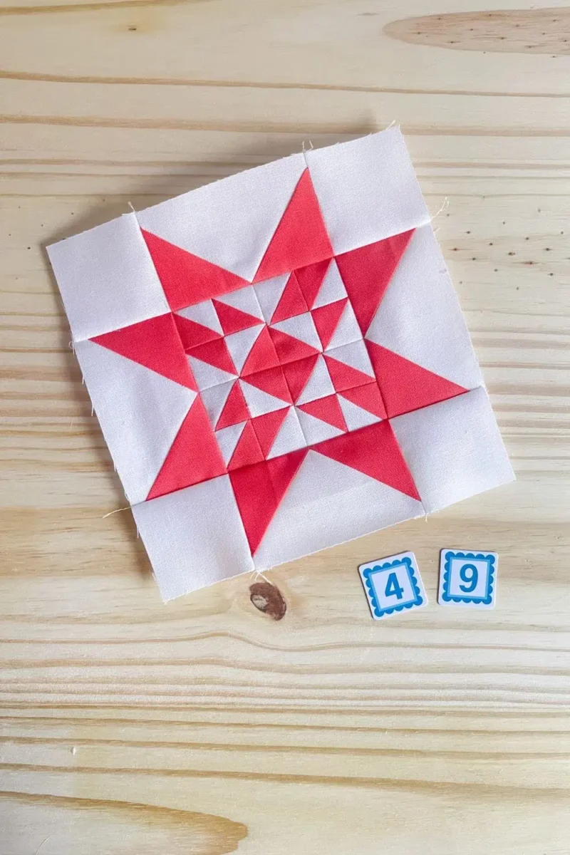 Star quilt block in red and white. Made with 16 half square triangles in the center part of the star.