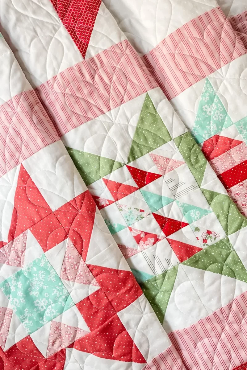 3 star quilt blocks in the Adore quilt with Lighthearted fabric collection. Quilt has pink sashing between the blocks