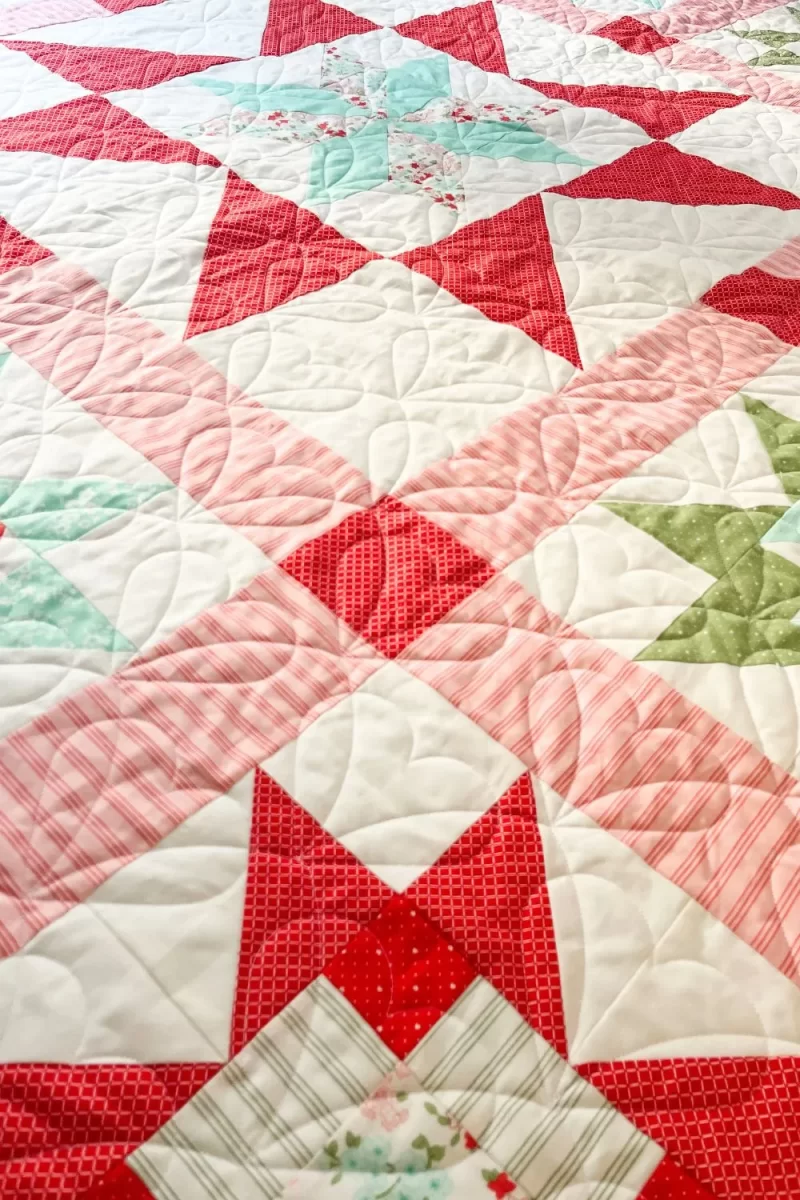 Heart edge to edge stitching by a Handi Quilter long arm on the Adore quilt