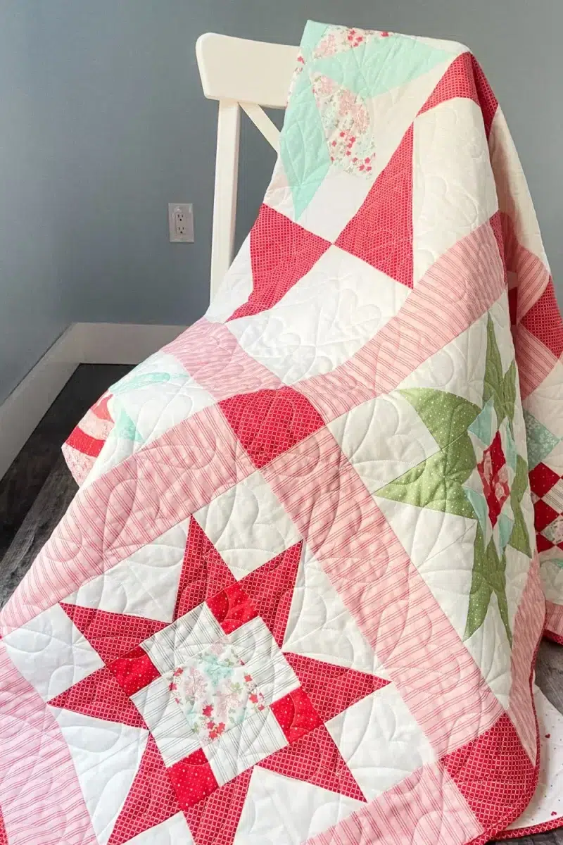 Adore quilt draped on a white chair.
