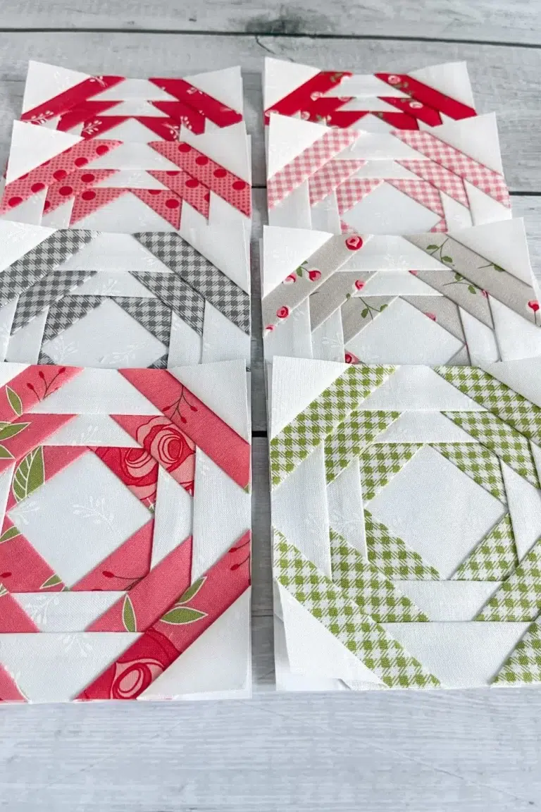 8 two colored pineapple quilt blocks. All are white with one other color: pink, red, dark pink, green, or grey.