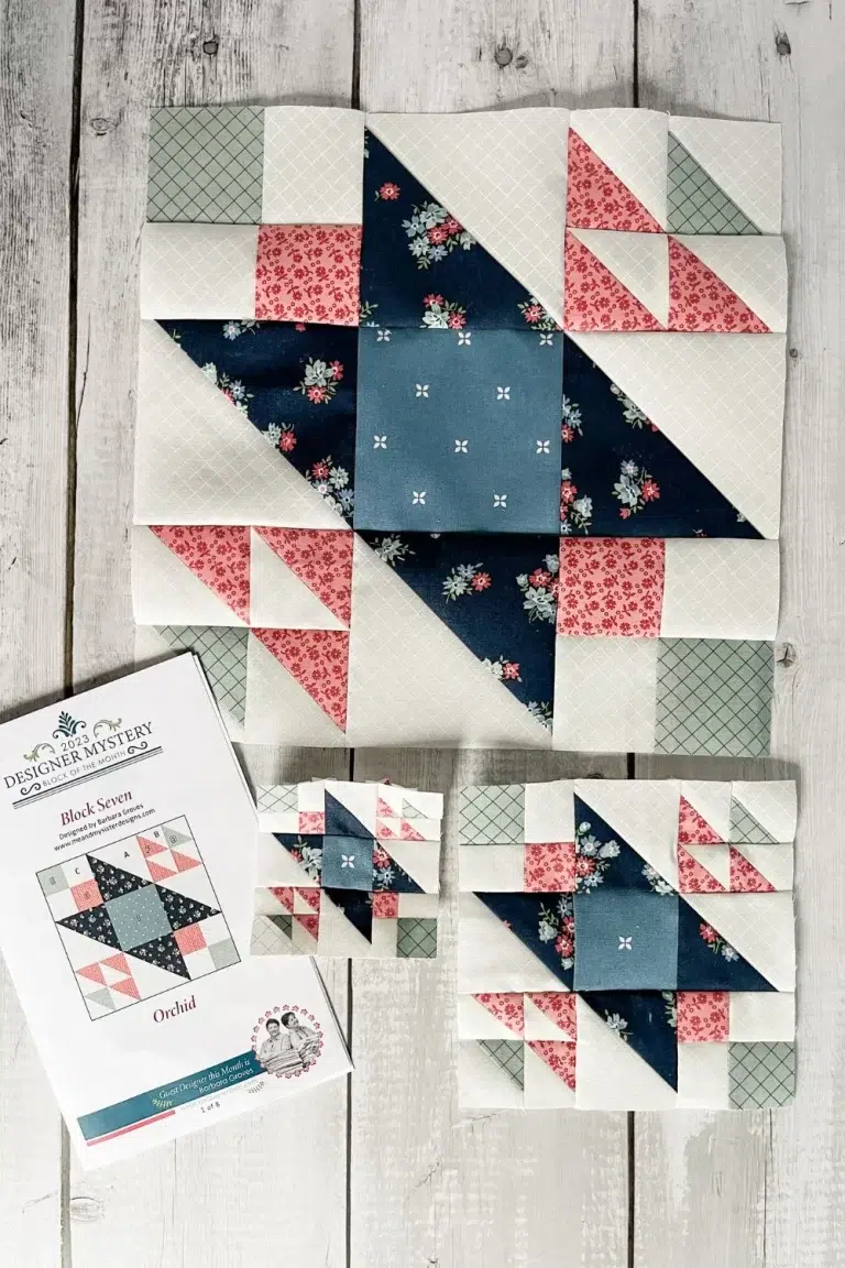Three sizes of the same quilt block. The block is the Orchid block from month 7 of Designer Mystery. It is shown in white, pink, navy, and sage green fabrics.