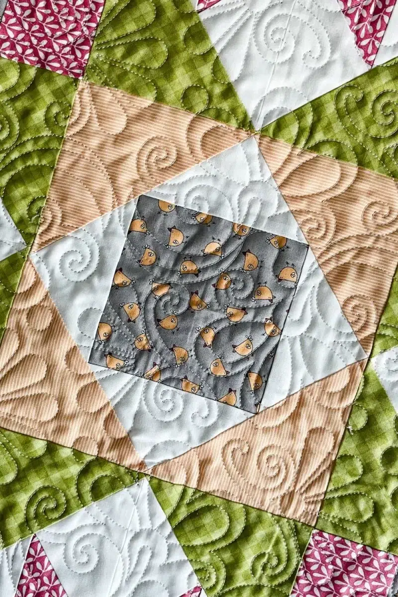 Close up of a star block and the longarm quilting.