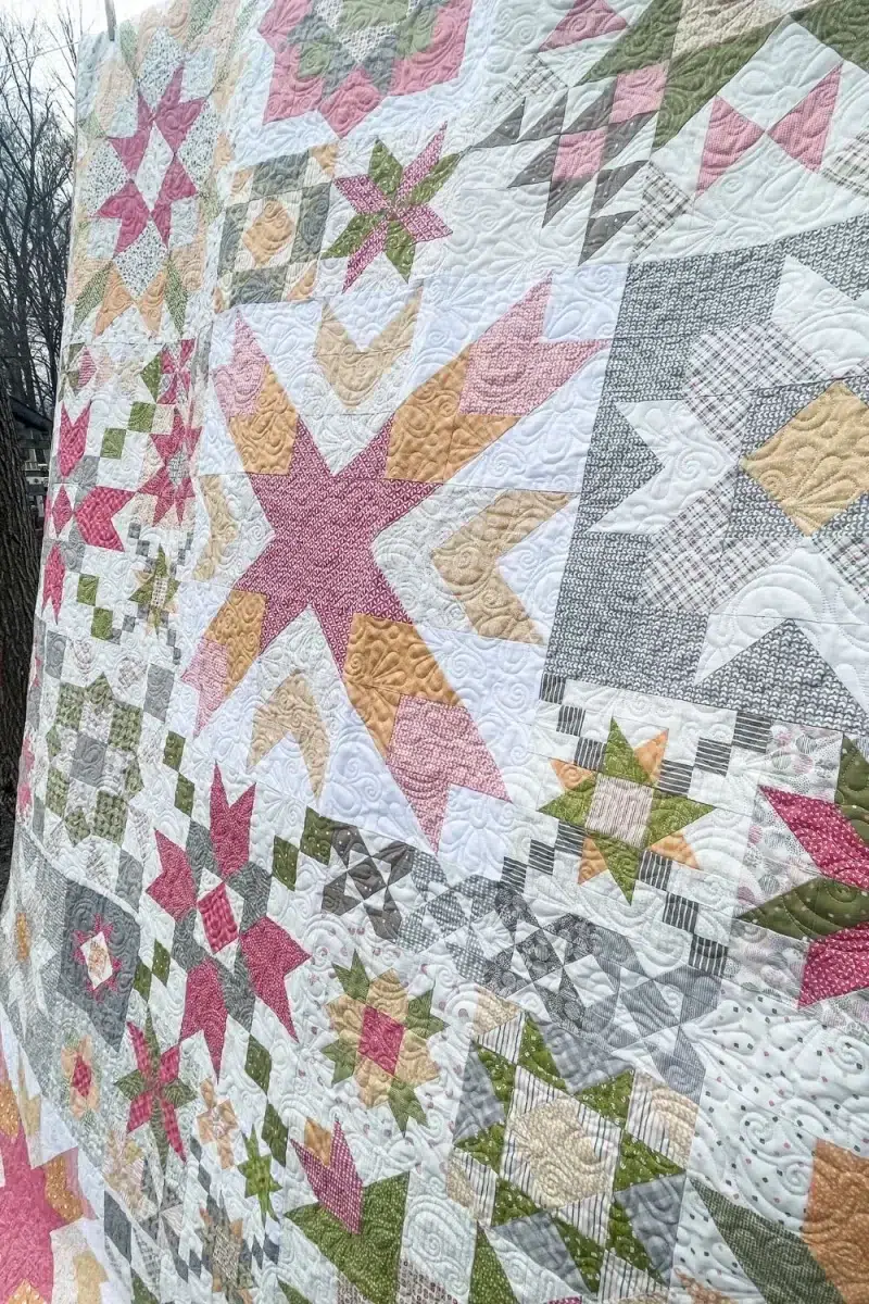 Side view of the Barn Star Sampler Quilt and a close up of the long arm quilting.