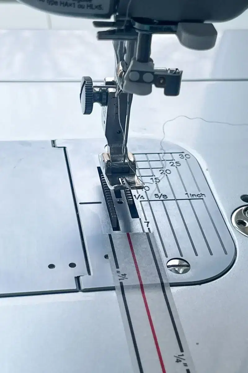 Finished application of diagonal seam tape on a sewing machine bed.