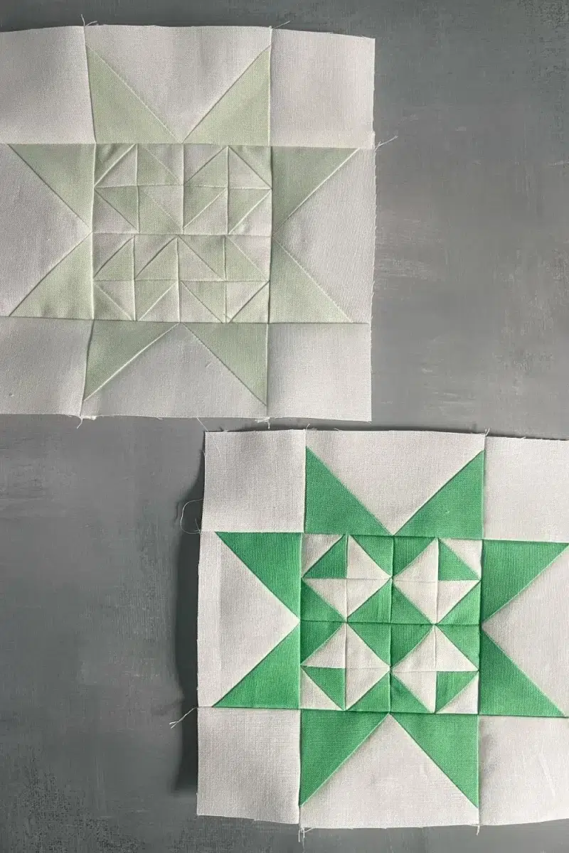 2 quilt blocks from the Triangle Gatherings Quilt Book. Made up of 16 half square triangles in the center and flying geese star points. One block is light green and white, the other is green and white.