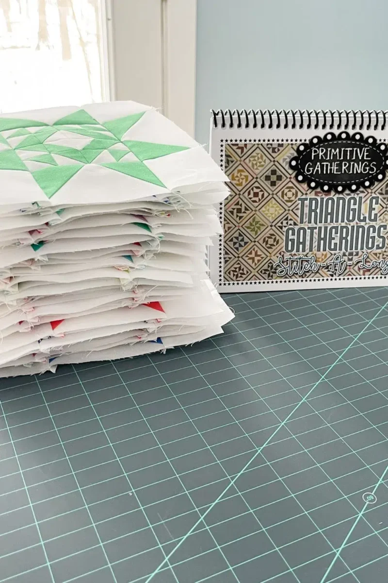 Stack of triangle gatherings quilt blocks and the pattern book