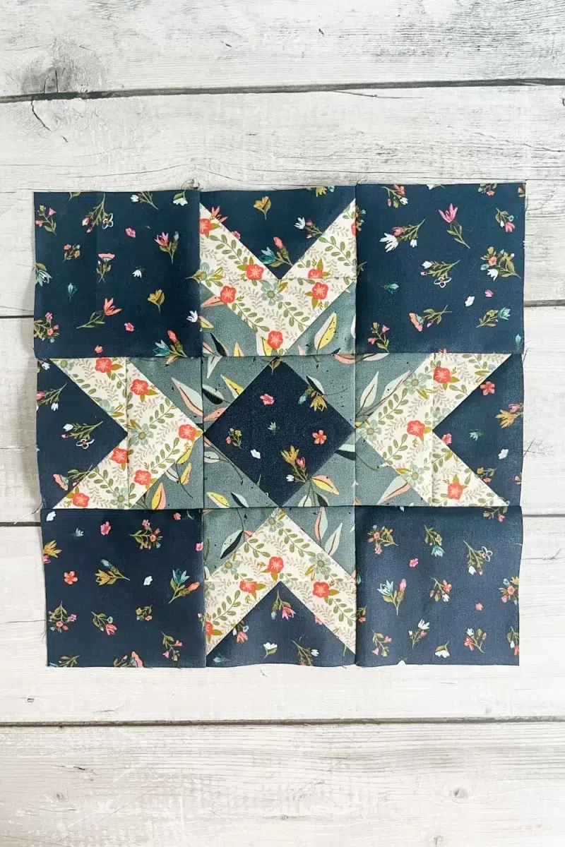 Glimmer quilt block made with flying geese and square in a square