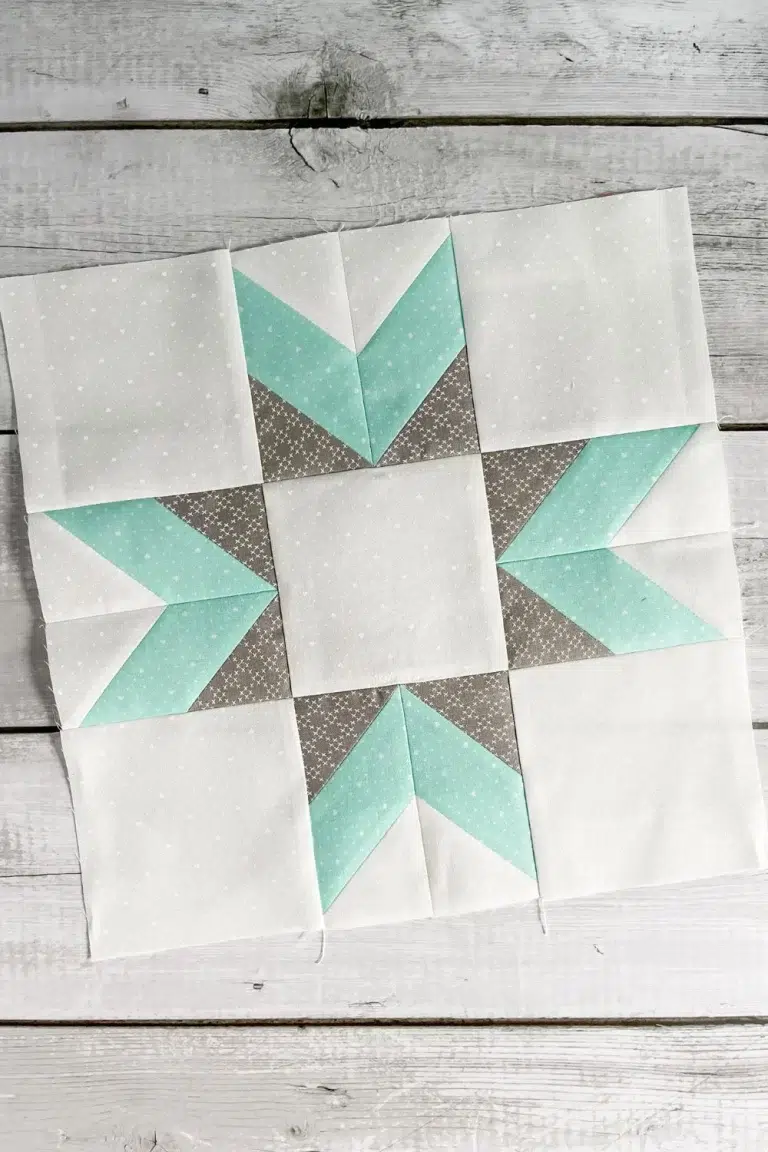 Double star quilt block in teal, grey, and white Lighthearted fabric.