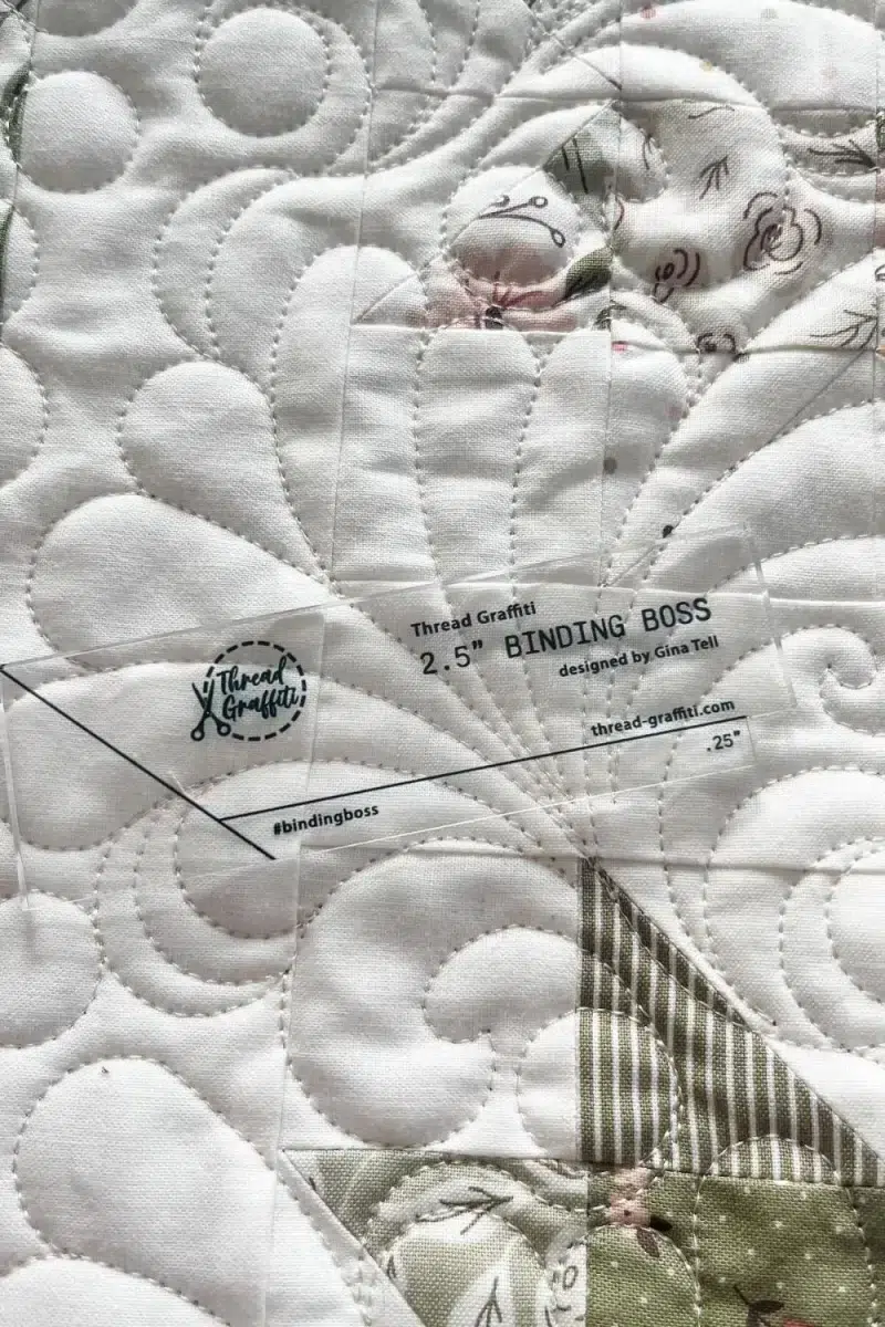 Binding Boss tool by Gina Tell of Thread Graffiti. This tool is a measure-free way of connecting your quilt binding while sewing it on to your quilt.