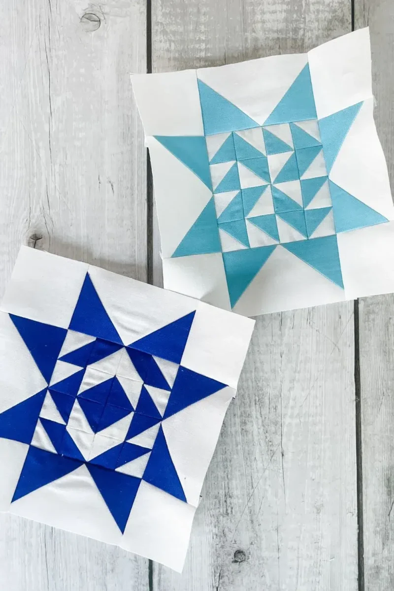 Two quilt blocks for the Twilight Stars Quilt Along. One navy and white and the other is light blue and white. Uses half square triangles arranged to make the center and flying geese and corner squares to complete the quilt block.