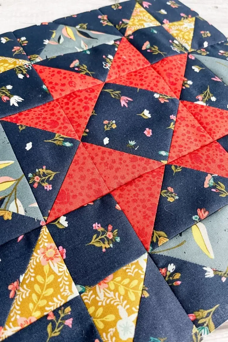 Moda Blockheads 5 group 2 block 1 shown at an angle. The Dream Big star block made with Fancy That Design House's fabric collection Songbook.