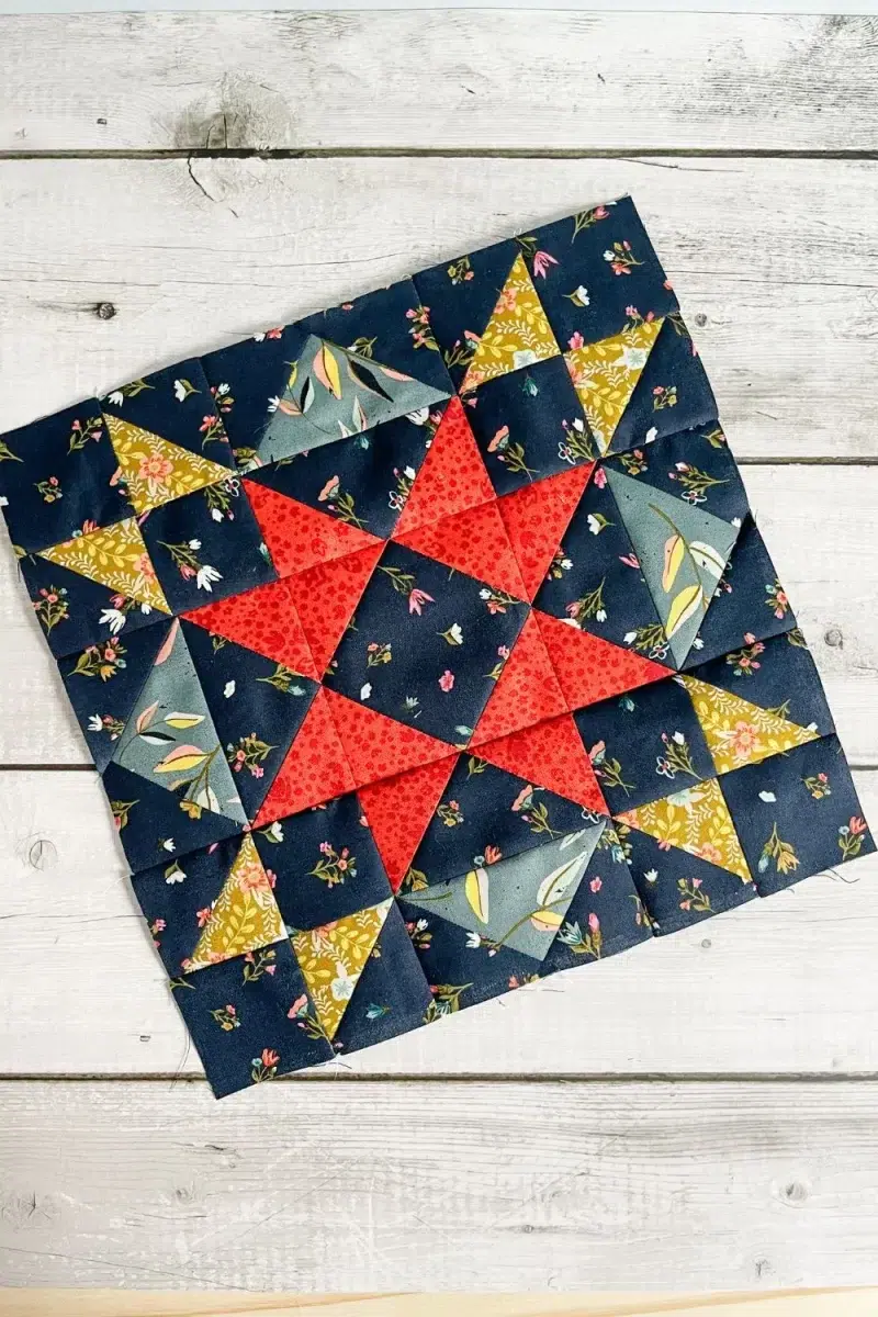 Moda Blockheads 5 group 2 block 1 shown overhead and slightly tilted. The Dream Big star block made with Fancy That Design House's fabric collection Songbook.