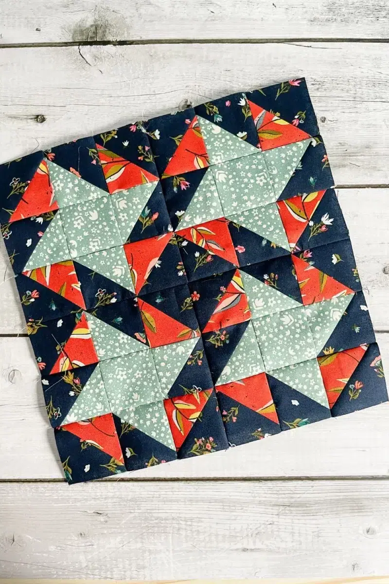 Moda Blockheads 5 group 2 block 2 shown overhead at an angle. The All Stars block made with Fancy That Design House's fabric collection Songbook.