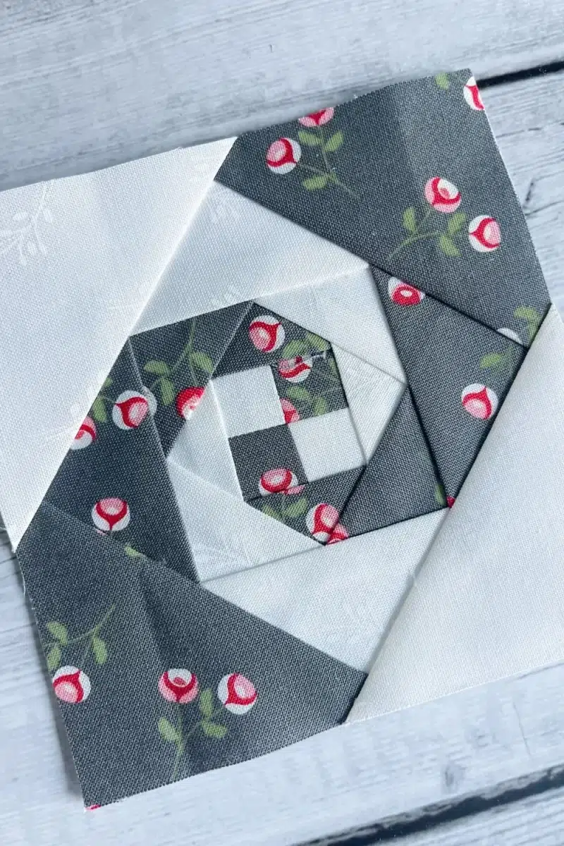 Close up of the intricate Snail Trail quilt block that resembles a double spiral.