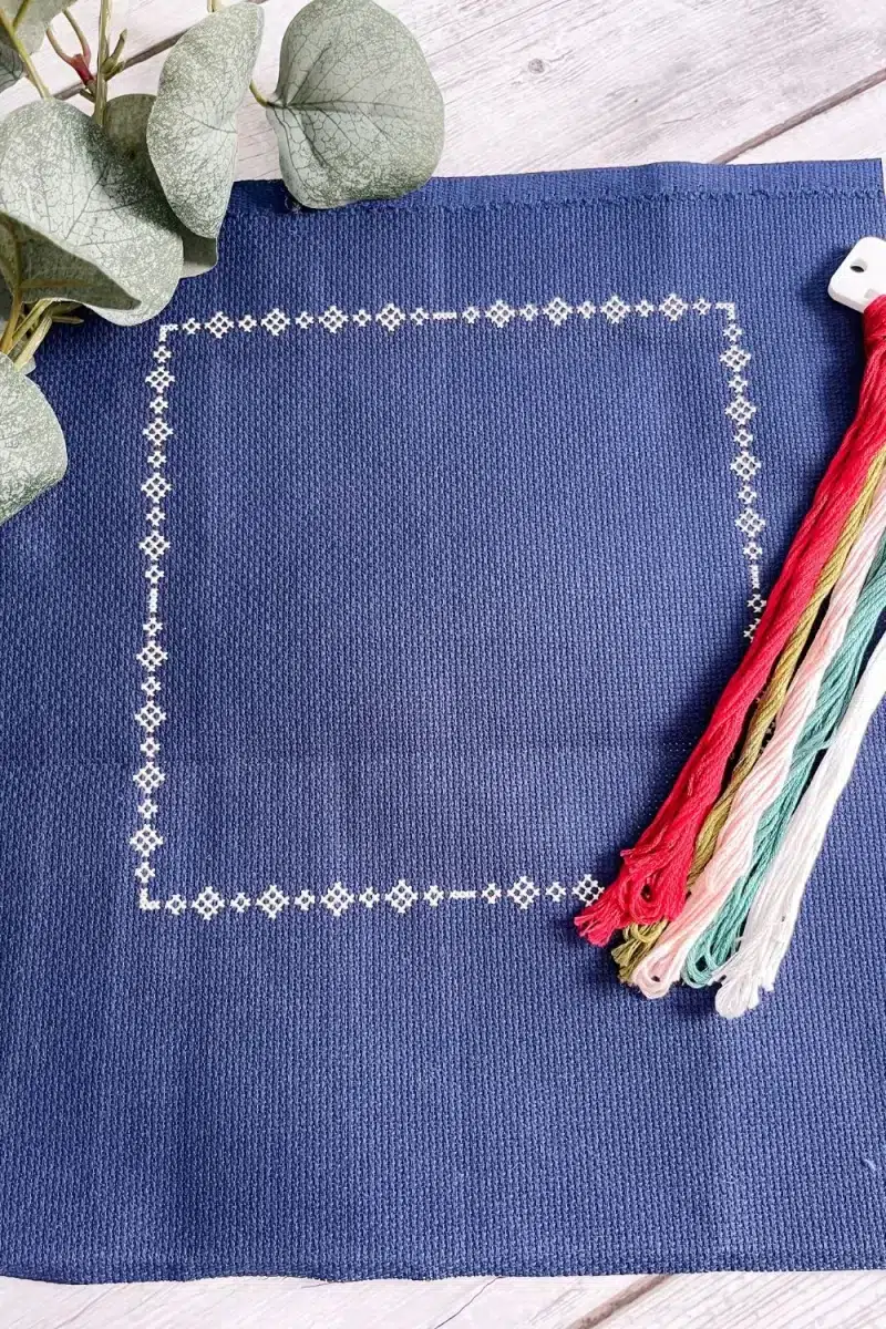 Navy Aida cross stitch fabric with the border stitched in white for the Moonbeams coordinating cross stitch