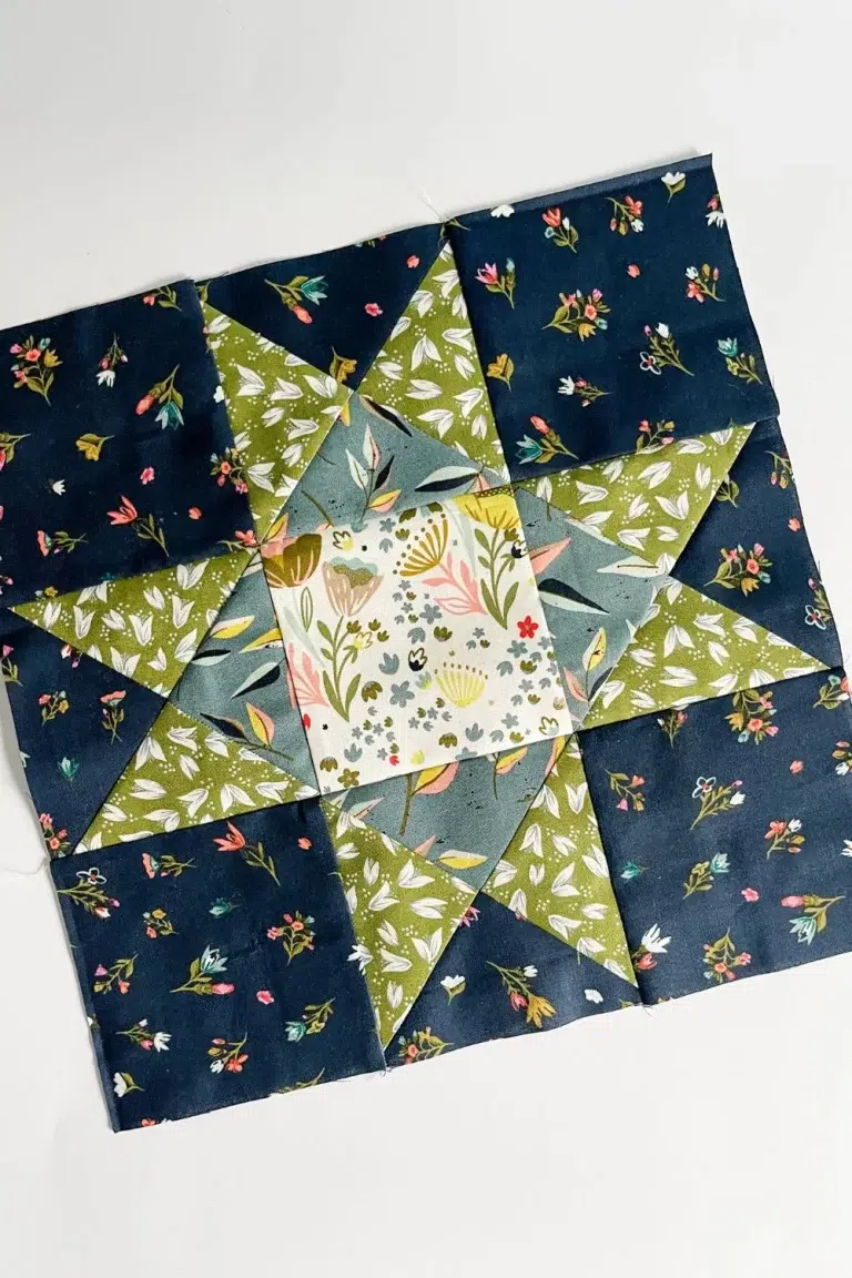 Ohio Star quilt block in green, navy, blue, and white floral prints