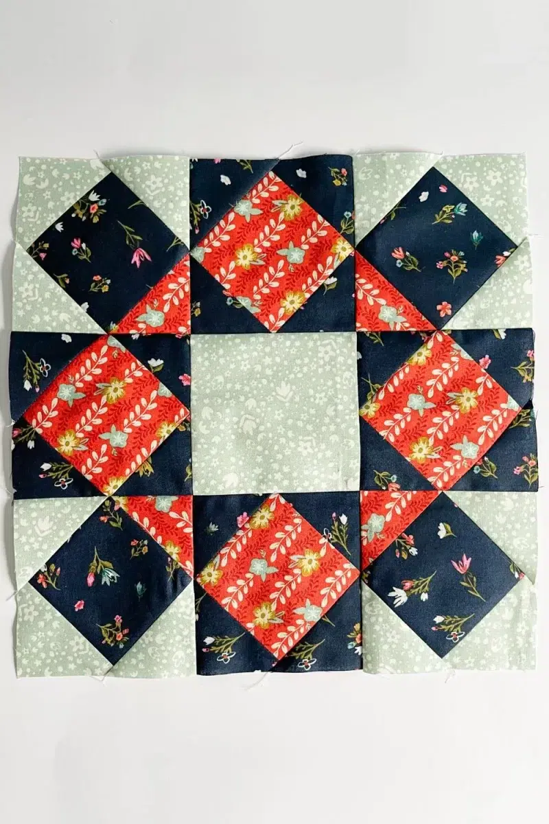 Star Bloom quilt block made with square in a square blocks in a 9 patch arrangement