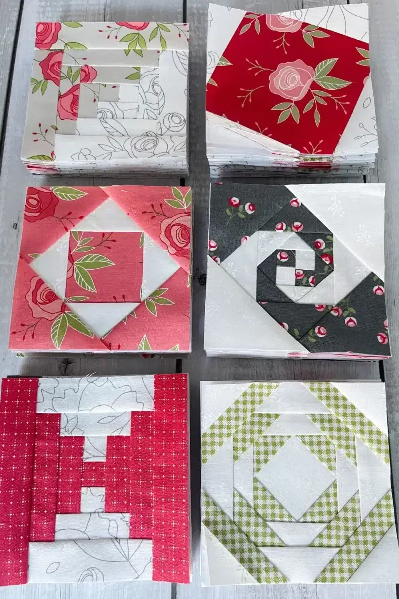 6 piles of completed quilt blocks in 4" size using foundation paper piecing. Log cabin, sparkle star, economy blocks, snail trail, courthouse steps, and pineapple blocks.