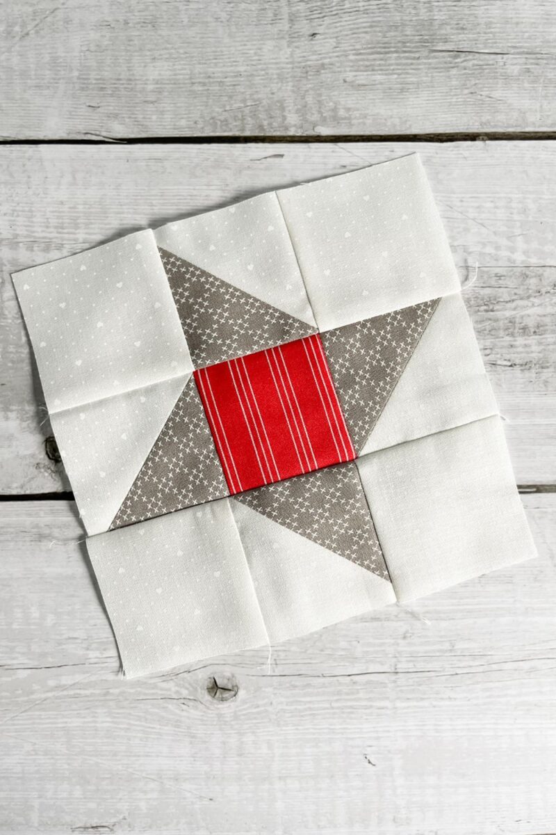 The Friendship Star quilt block is a simple block of a center square surrounded by 4 half square triangle units.