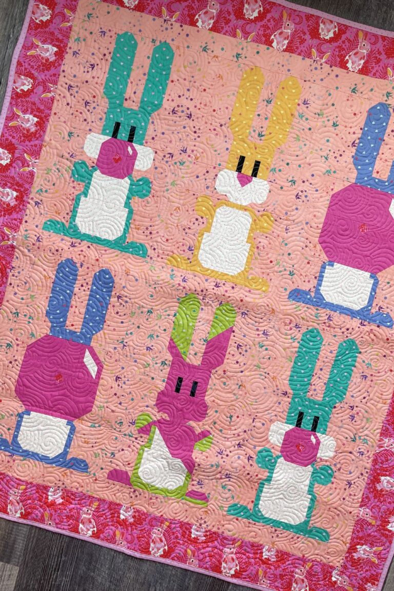 Overhead view of the entire Blowing Up Bunnies Quilt made with 6 bunny blocks showcasing Tula Pink True Colors and Besties fabrics.