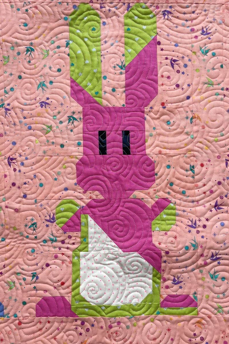 Close up image of a bunny block with a popped bubble gum bubble all over it.