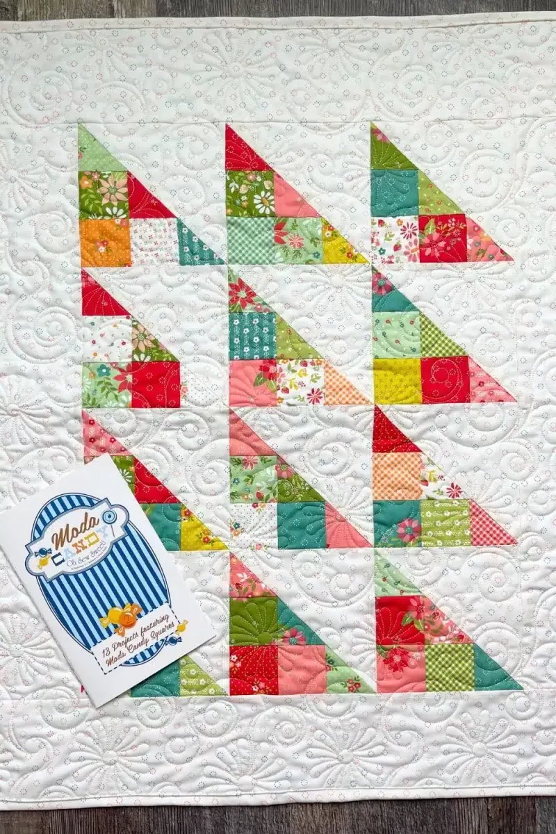 Mini charm pack quilt made with Strawberry Lemonade fabric collection. Moda Candy quilt booklet has 13 projects using 2.5 inch squares
