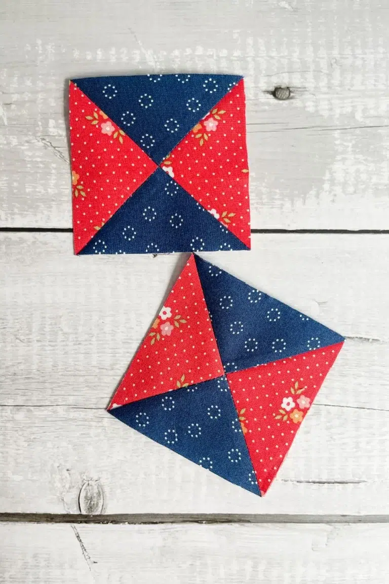 Two completed and trimmed hourglass quilt block units in red and navy