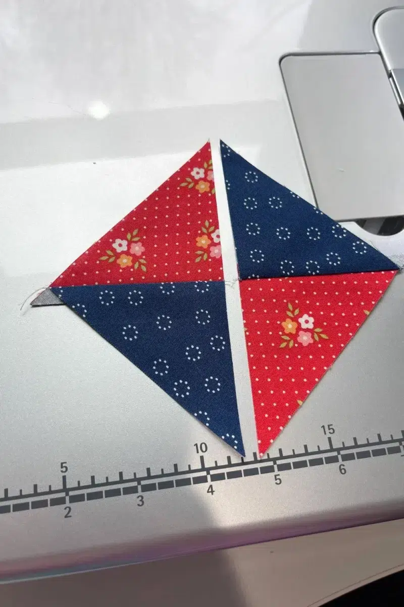 Two halves of a hourglass quilt block unit ready to be sewn together