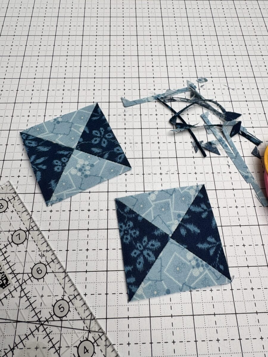 Two trimmed hourglass blocks and a quilting ruler