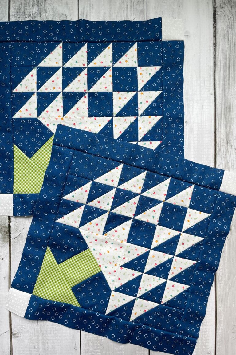 Two Tree of Life quilt blocks made with blue background fabric, white "leaves" and a green "tree trunk"