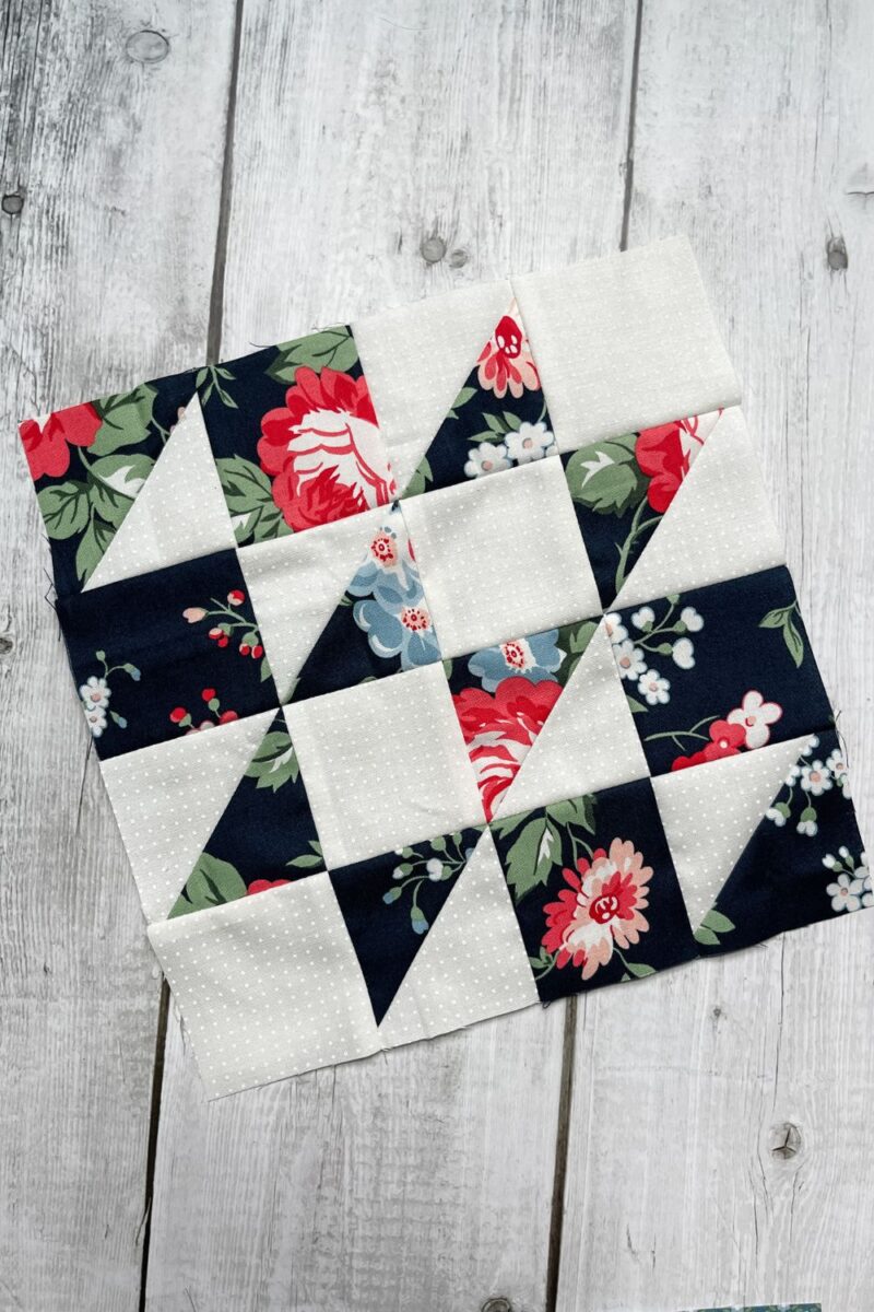The Hovering Hawks block made with a white dot fabric and a large floral fabric from the Dwell fabric collection.