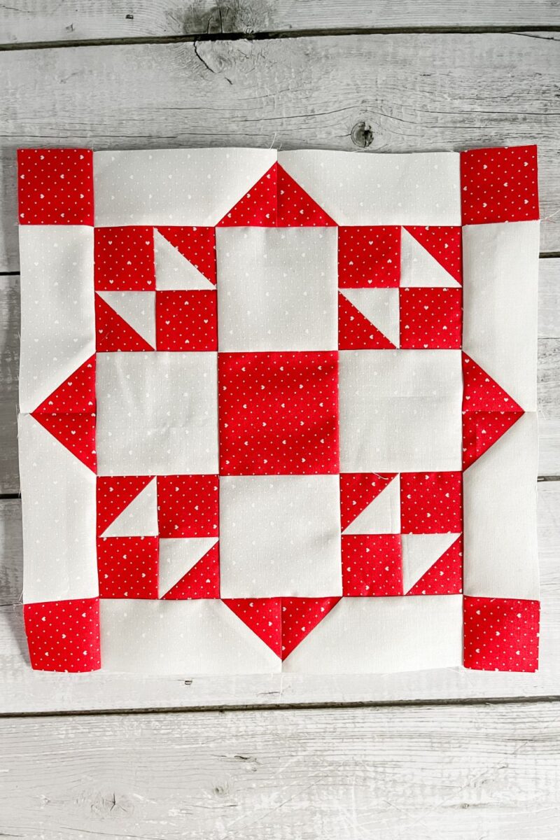 Starburst quilt block made in red and white.